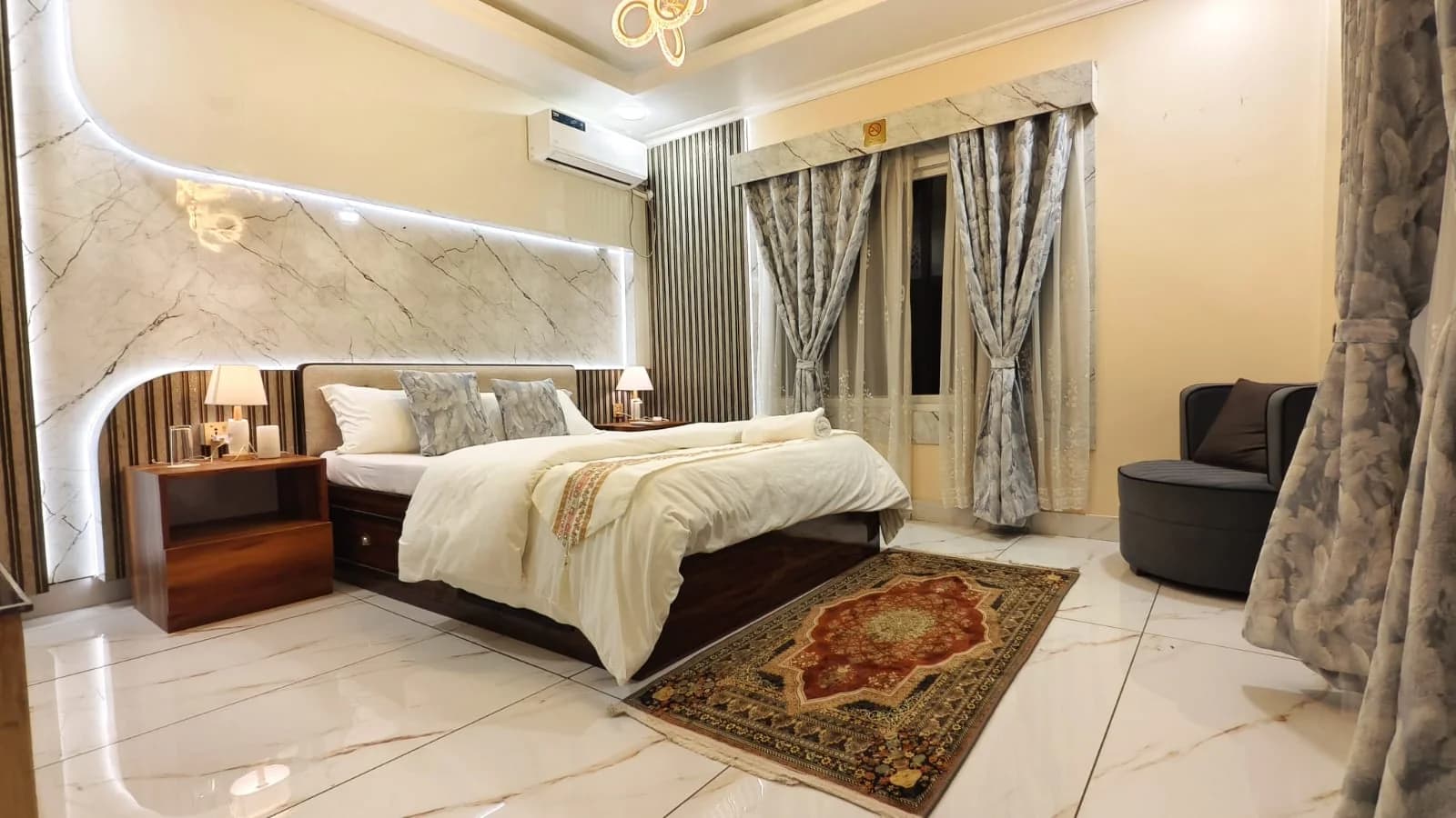 Bedroom two at Omnia Luxe Villa with marble accent wall