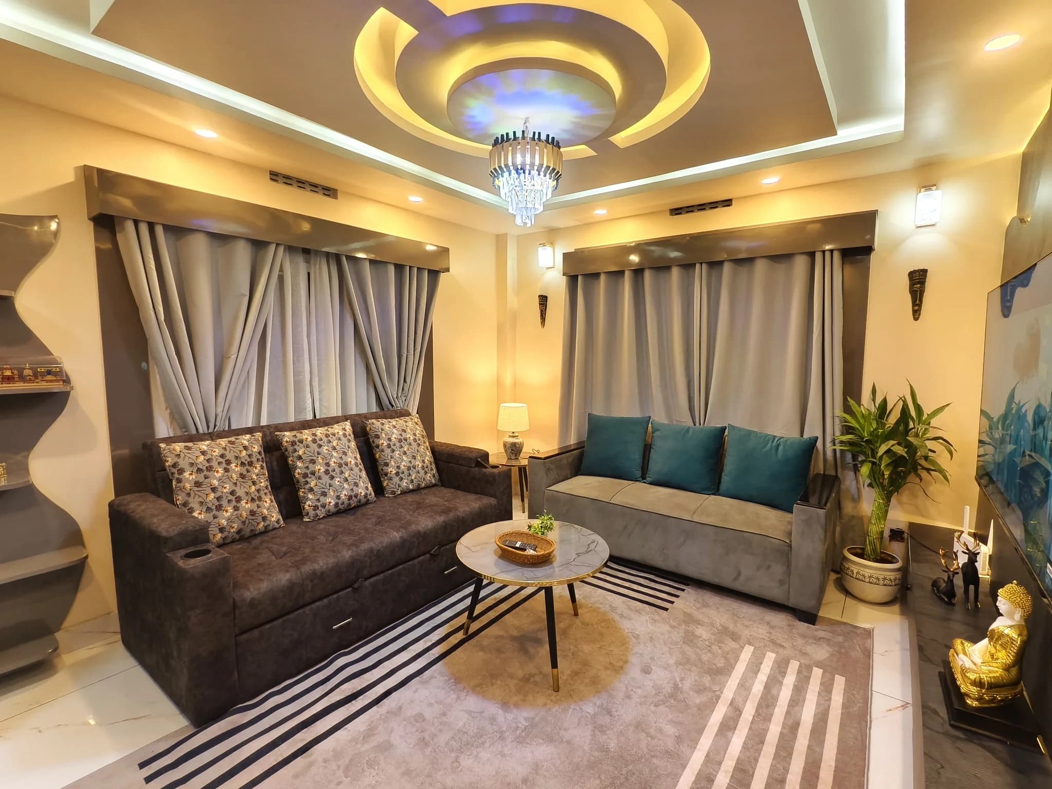 Living room with twin sofas and sculpted ceiling