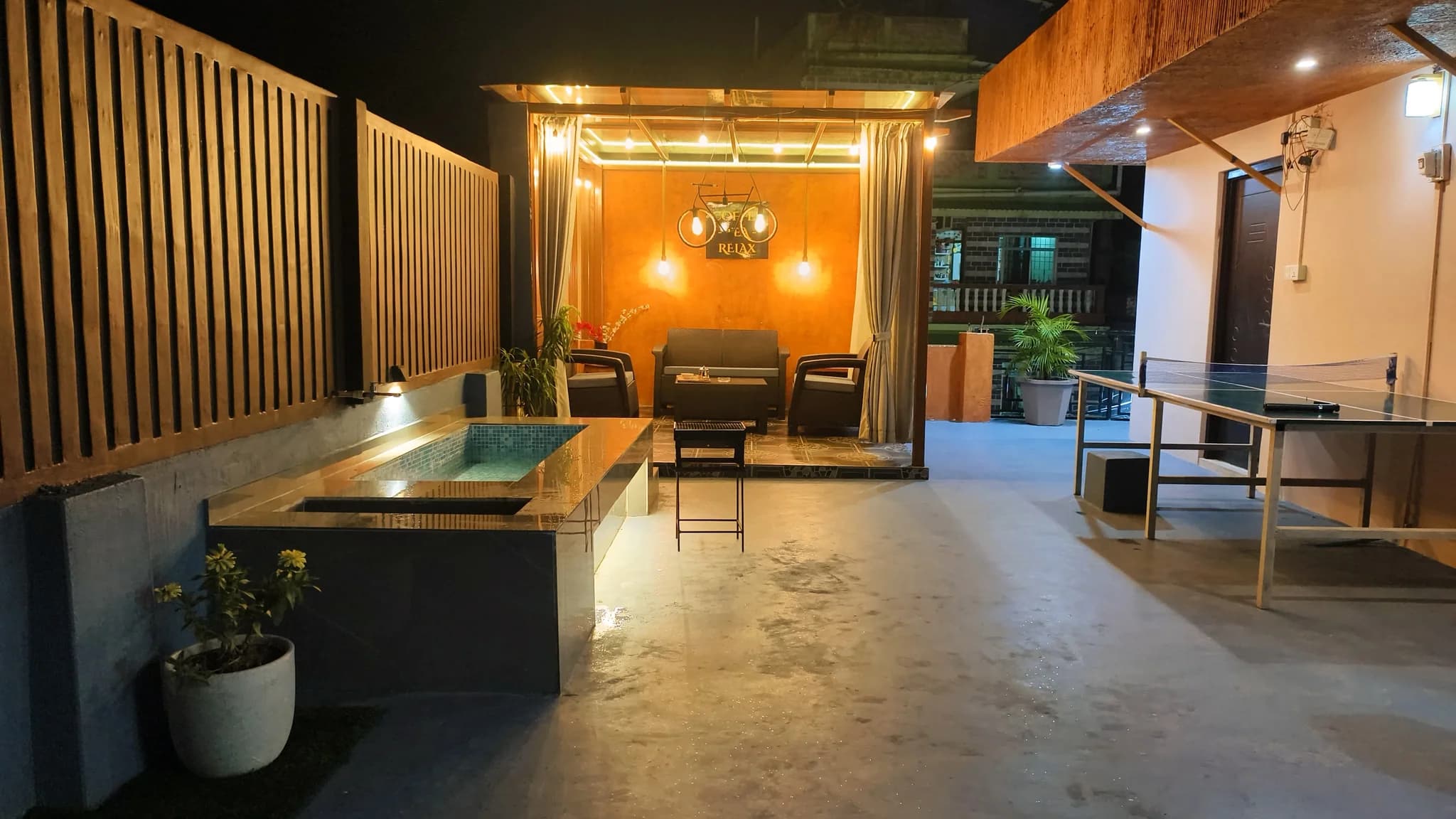 Rooftop wide view with lit pergola lounge